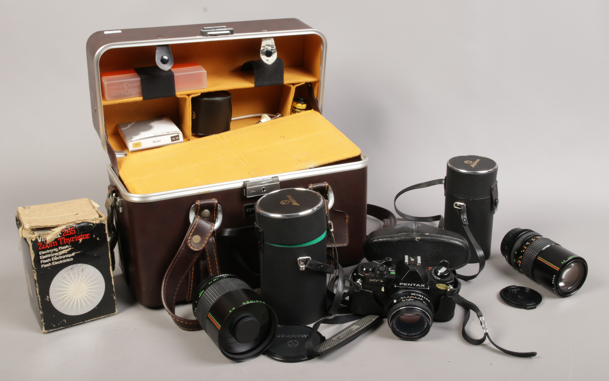 A photographic carry case and contents of Pentax MV 1 camera, Makinon lenses f = 80 - 200mm, f =