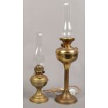 Two Victorian brass oil lamps with later floral milchglas shades.