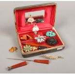 A musical jewellery box containing mixed vintage costume jewellery including Bakelite, amber and