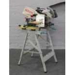 A Bosch GCM8S chop saw mounted on a Wolfcraft 100 folding workmate / stand with instruction