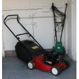 A Briggs & Stratton 35 classic petrol lawn mower, along with an Andrew James electric cultivator.