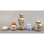A collection of oriental pottery and ceramics to include lidded baluster shaped vase, ginger jars