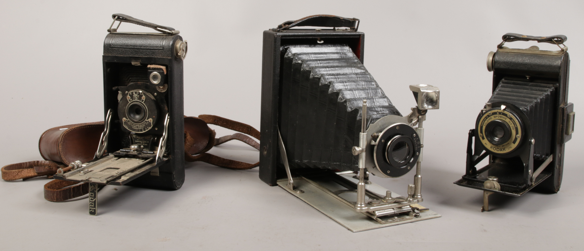 An early to mid 20th century folding Bellows half plate camera, along with a Kodak folding Brownie