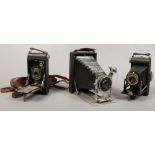 An early to mid 20th century folding Bellows half plate camera, along with a Kodak folding Brownie