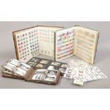 Two albums of British and world stamps, along with a quantity of cigarette cards and two albums of