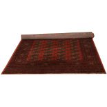 A red ground Bokhara wool rug 19.8cm x 14cm.