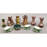 A collection of glazed pottery to include Watcombe Torquay ware, Fosters fish jug and a chipped