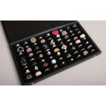 72 dress rings in display case to include yellow and white metal, colour paste stone examples etc.