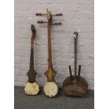 Three strung musical instruments, two Indian and an African example.