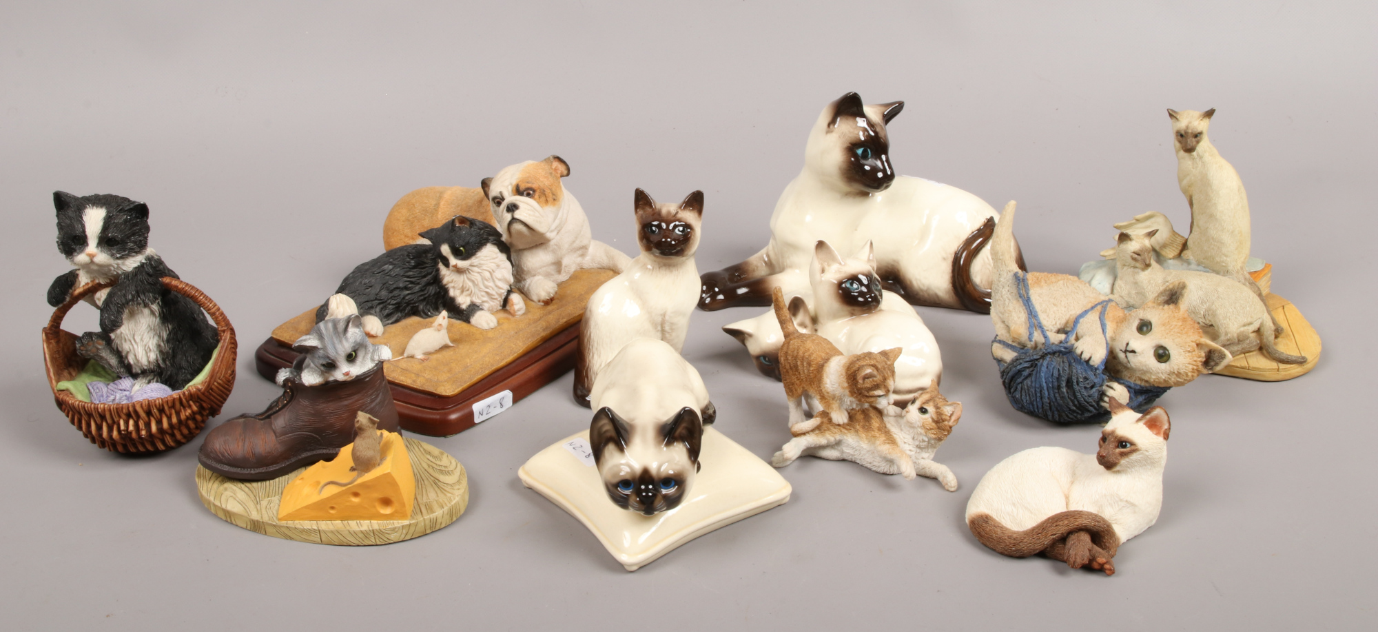 A collection of composite and ceramic cat figures to include Beswick, Sherratt and Simpson etc.