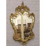 A decorative gilt metal framed mirror, 115cm x 70cm.