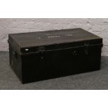 A black metal twin handle military trunk stencilled CPL Fisher.