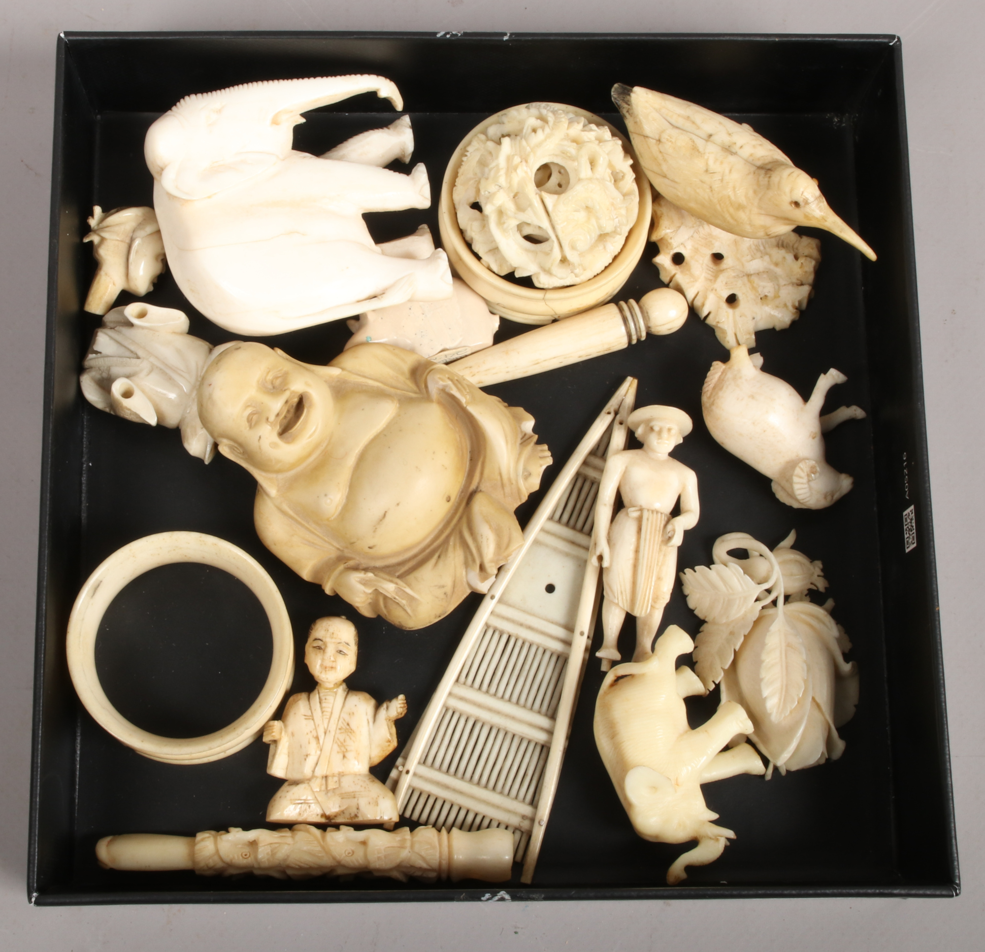 A group of bone carvings mainly 19th century; puzzle ball, beetle, elephants and figures, cheroot