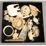 A group of bone carvings mainly 19th century; puzzle ball, beetle, elephants and figures, cheroot