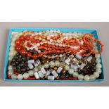 An assortment of vintage jade coral and hardstone bead necklaces.