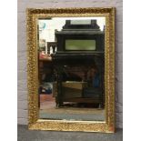 A large gilt frame bevel edge wall mirror, 108cm x 76cm