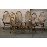 A set of six Ercol spindle back dining chairs to include two carvers.