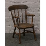 An early 20th century child's ash and elm spindle back arm chair.Condition report intended as a