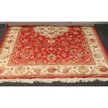 A red ground Keshan rug with floral medallion design, 285cm x 200cm.