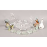 A cut and etched glass decanter, fruit bowl, floral napkin rings, ornamental clear glass golfer,