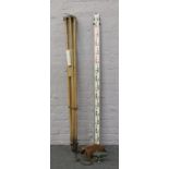 A Hilger & Watts leather cased dupy level on wooden tripod stand along with telescopic height