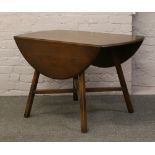 An Ercol drop leaf table on square cut splay legs.