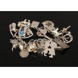 A silver charm bracelet to include animal charms, windmill charm etc, weight 64 grams.