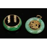 An 18ct gold mounted jadeite ring and similar Chinese pendant ornamented with a dragon.