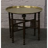 An Indian brass folding base table.