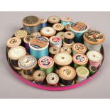 A quantity of vintage cotton reels of various sizes including J & P Coats, Clark & Co. Sylko, W &