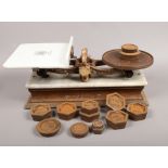 A set of Edwardian cast iron and ceramic scales by W & T Avery Limited with a collection of