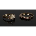 A 9ct gold ring set with white paste stones along with a gold plated ring set with red stones.