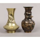 A Japanese Meiji period bronze vase decorated in relief with a dragon and a similar vase.