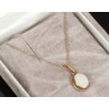 A 9ct gold mounted oval opal pendant on 9ct gold chain.