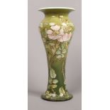A Doulton Lambeth faience baluster shaped vase by Agnes E. M Baigent, green ground and decorated