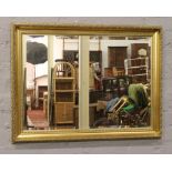 A gilt frame bevel edge wall mirror.