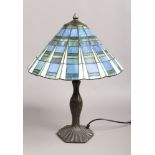 A Tiffany style table lamp with leaded and coloured glass shade.