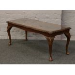 A carved mahogany inlaid glass top coffee table, raised on cabriole legs.