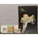A quantity of Marilyn Monroe memorabilia including postcards, books and a poster.