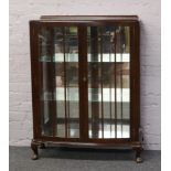 A mahogany display cabinet with mirrored back.