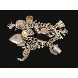 A silver charm bracelet to include love heart charms, rings, ballet charm etc, weight 62 grams.