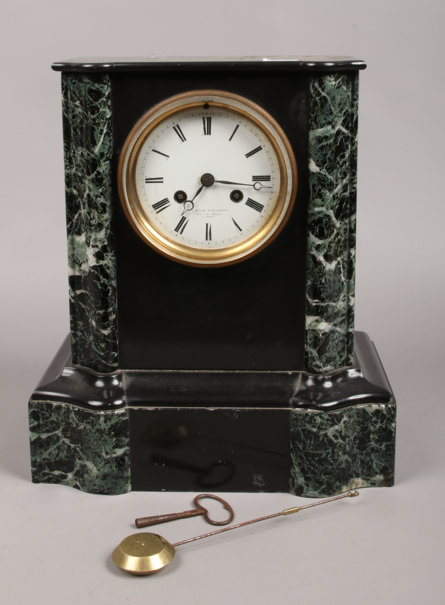 A French slate and marble 8 day mantel clock by F. Poulet Paris chiming on a bell.