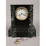 A French slate and marble 8 day mantel clock by F. Poulet Paris chiming on a bell.