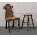 A carved oak hall chair, along with an oak stool.