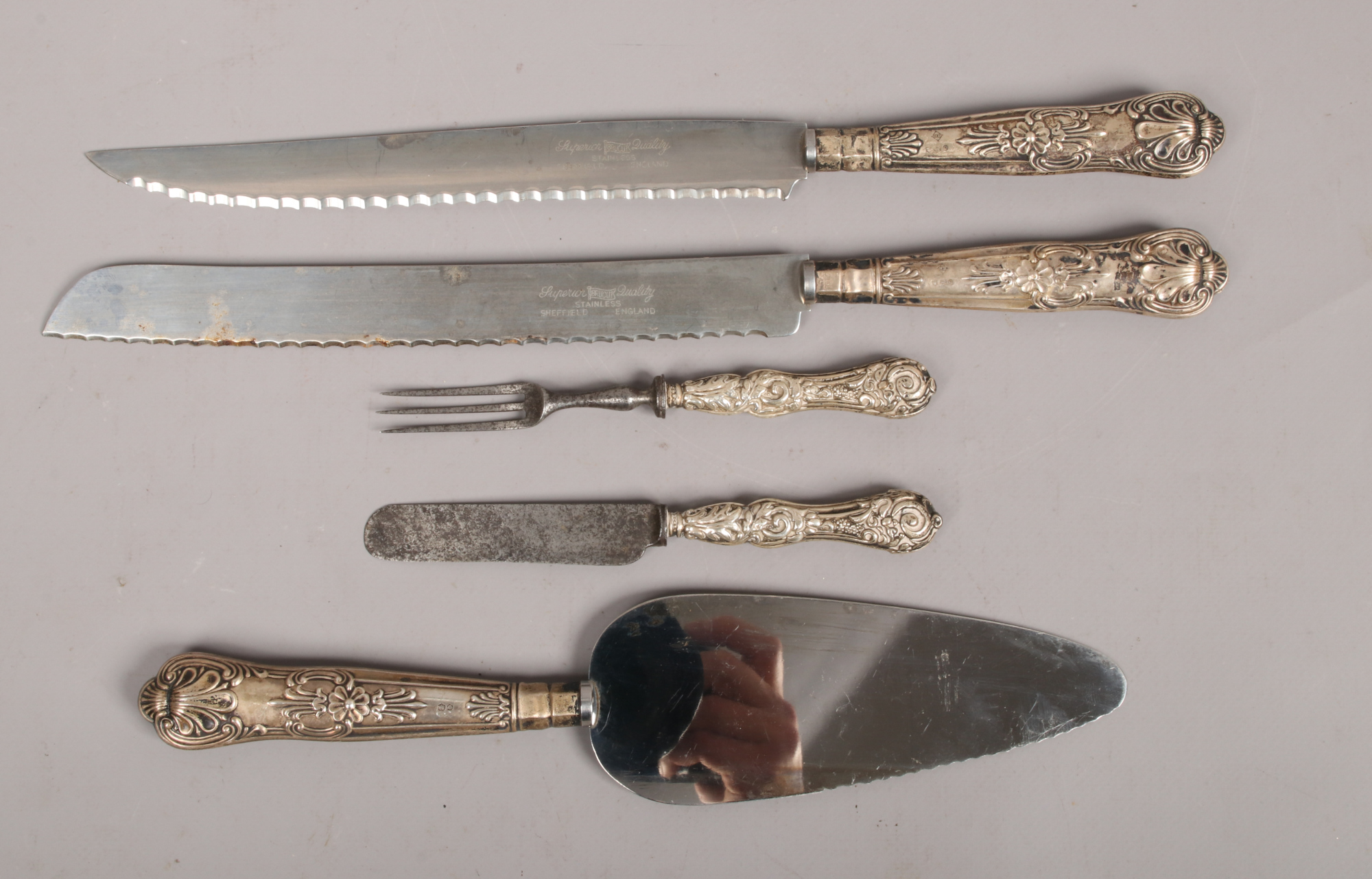 Five silver handled items of cutlery with various assay marks to include London / Sheffield in the