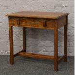 A carved oak side table with single drawer.