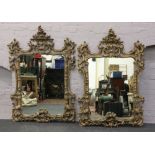 A pair of large decorative gilt framed mirrors. 145cm x 100cm.