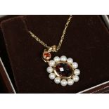 A 9ct gold garnet and pearl pendant on chain.