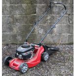 A Mountfield RS 100cc petrol driven lawnmower and grass box.