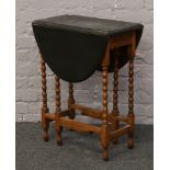 A drop leaf table with bobbin turn supports and painted top.
